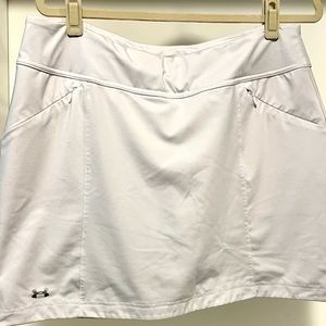Women’s UNDER ARMOR BRAND white golf (or tennis) skirt with shorts underneath.